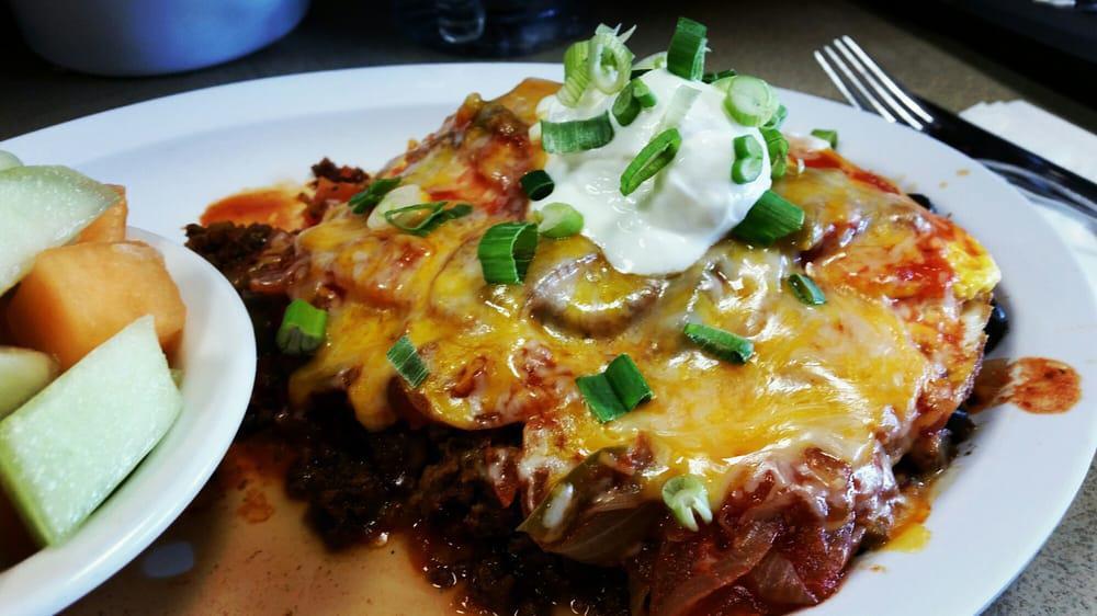 Huevos Rancheros · Fried corn tortilla topped with chorizo, black beans, olives, onions, tomatoes, cheddar and jack cheeses topped with salsa, sour cream, chives, and two eggs. No toast.