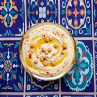 Hummus · Made from a blend of chickpeas, garlic, tahini, lemon juice, topped with olive oil.