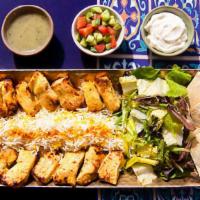 Jetset Chicken And Rice Platter · Tender charbroiled chicken skewers over rice. Served with greek salad, tzatziki, and pita.