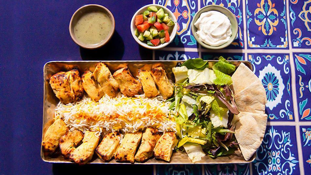 Jetset Chicken And Rice Platter · Tender charbroiled chicken skewers over rice. Served with greek salad, tzatziki, and pita.