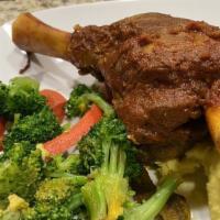 Lamb Shank · Gluten free. Braised lamb shank cooked to perfection in tomato sauce served with roasted gar...