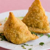 Vegetable Samosas · Vegan. Pastry stuffed with seasoned potatoes and peas. Two pieces.