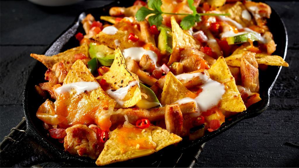 Mas Nachos · Hot & Crisp Mexican-style chips topped with a generous helping of cheese, guacamole, beans, mild sauce, sour cream and Salsa Fresca.