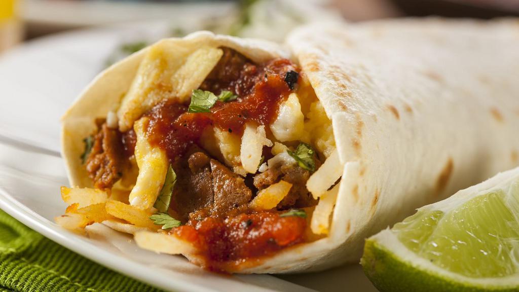 The Mucha Carne Burrito · Delicious overload of marinated, shredded steak and cheese wrapped into a soft tortilla with guacamole and salsa fresca.