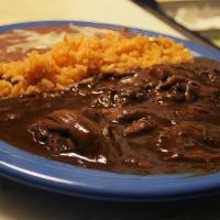 Mole Poblano · Shredded Chicken cooked to Perfection in our special Mole Sauce. Served with Rice/Beans and ...