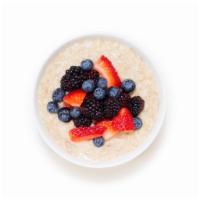 Berry Oatmeal Bowl · Warm rolled oats made with almond milk and topped with blueberries, strawberries, and almonds.