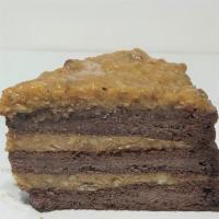 German Chocolate cake · German chocolate cake layered and topped with coconut and pecan glaze.