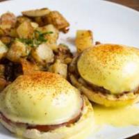 Eggs Benedict  · 2 poached eggs, Canadian bacon on an English muffin, topped with hollandaise sauce, and serv...