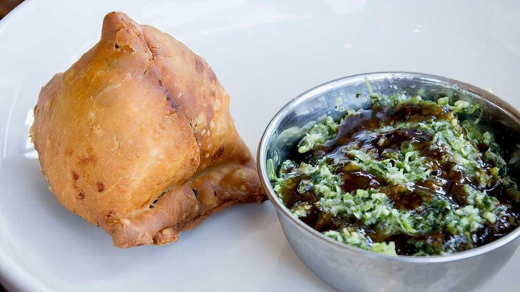 Samosa (1) · A single crunchy savory pastry stuffed with spicy potatoes and peas. Served with zingy cilantro and sweet tamarind chutneys. Vegan