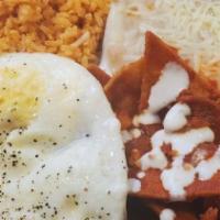 Chilaquiles · Tortillas cooked in homemade sauce  served with 2 eggs and beans.