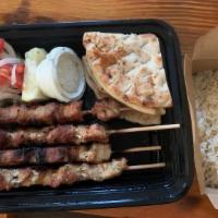Pork Souvlaki Pita · Skewered pork wrapped in pita bread filled with tomatoes, onions, tzatziki and a few French ...