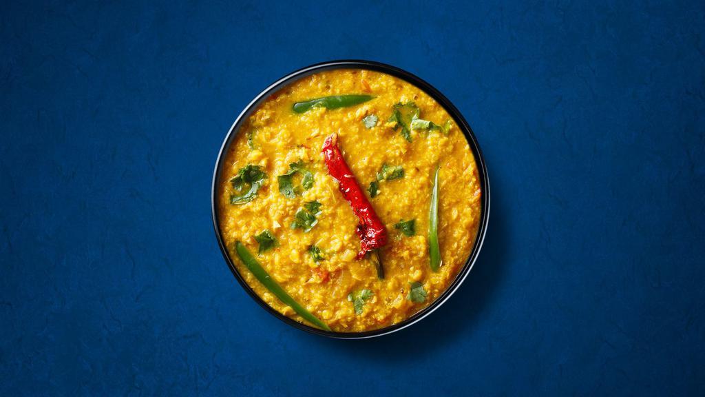  Divine Yellow Lentils  (Vegan) · Yellow lentils, slow-cooked to perfection and tempered with cumin, garlic, and chilies. Served with a side of aromatic white rice.