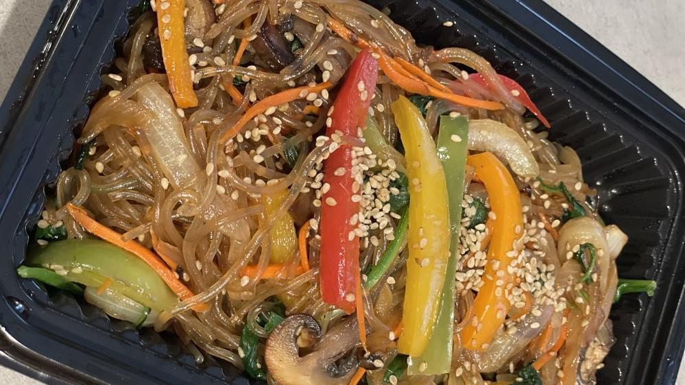 Japchae · Authentic Korean glass noodles with onions, green onions, mushrooms, and carrots. Made with sesame oil and garnished with sesame seeds