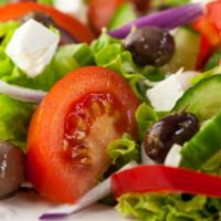 Greek Salad · Romaine, tomatoes, cucumbers, olives, marinated onions, and feta cheese tossed with homemade...