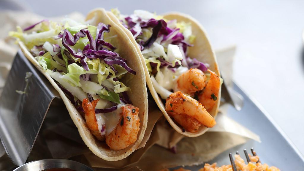 Grilled Shrimp Tacos · stone ground corn tortillas, tartar sauce, cabbage, served with fresh lime, salsa, spanish rice + cilantro black beans on the side [1020 cal].