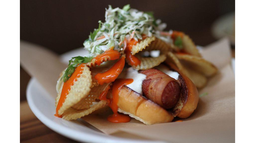 Dirty Dog · bacon-wrapped nathan’s hot dog in a bun, topped with potato chips, blue cheese dressing, buffalo sauce + slaw, served with fries [1740 cal]