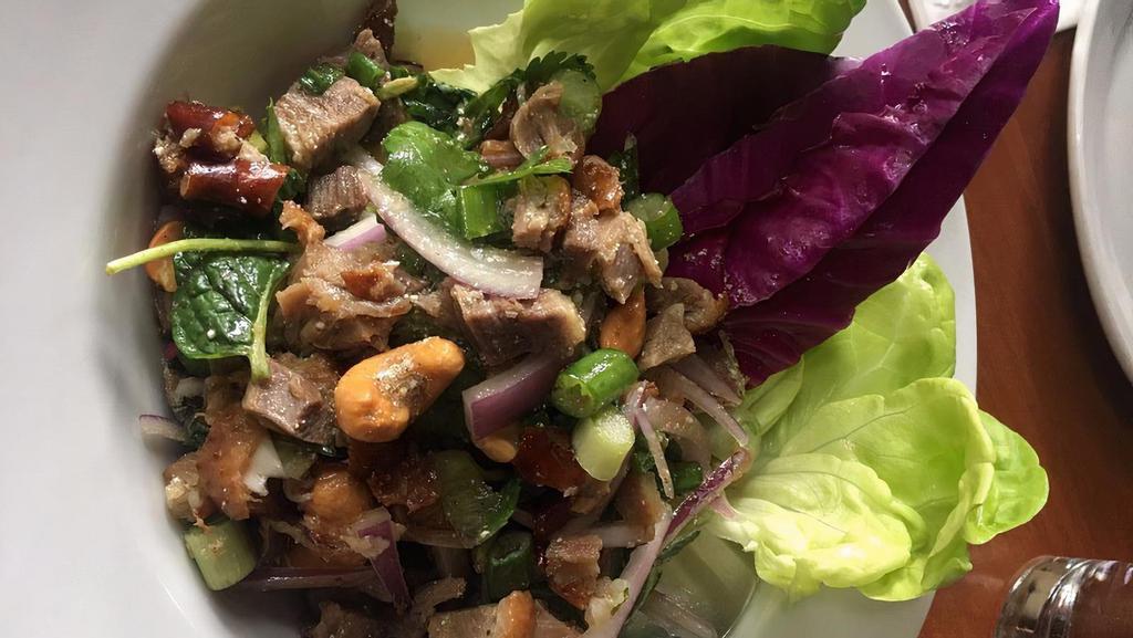 Larb Duck · Vegetarian available (tofu or braised gluten on some dishes) Spicy. duck or ground chicken with roasted rice powder, lime juice, mint, cilantro, red onion & cashews