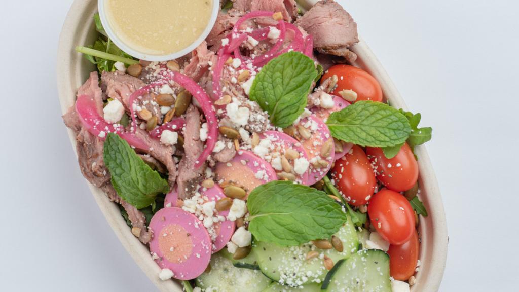 Mighty Med Salad · Super Greens, Steak, Grape Tomatoes, Pickled Egg, Cucumber, Pickled Red Onion, Lemon Tahini Vinaigrette, Feta Cheese, Mint, Superseed Crunch.