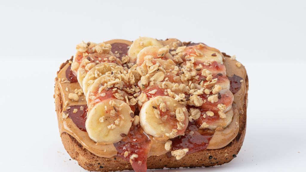 Pb & Chia Jam Toast · Whole Grain Bread, Peanut Butter, Sliced Banana, Strawberry Chia Jam, Granola.