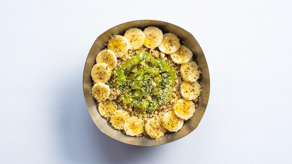 The Green Bowl · Base blend: graviola, almond milk, dates, spirulina, spinach, kale, strawberries, bananas.  Toppings:  organic granola, bananas, kiwi, hemp seeds, honey.  cal 410