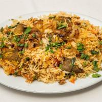 Goat Biryani · Goat cooked in basmati rice with chopped green and fried onions.