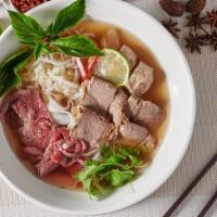 S1. Combination Beef Pho · Blanched filet mignon, sliced brisket, flank, tendon, tripe, rice noodles & fresh herbs in s...