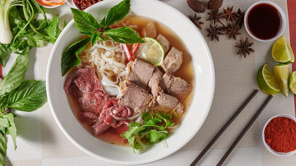 S1. Combination Beef Pho · Blanched filet mignon, sliced brisket, flank, tendon, tripe, rice noodles & fresh herbs in savory beef broth. There are fresh noodle.