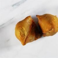 Samosa · 2 pieces. Deep fried potato and pea dumplings