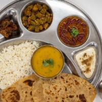 Daily Thali · Includes yogurt drink,  appetizer, two curries, daal, rice, 3 rotis and a dessert