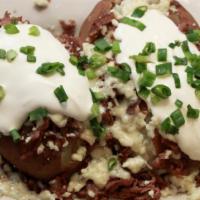 Steak & Bleu Cheese Potato · Thinly sliced sirloin, crumbled cheese, sour cream, green onions and butter.