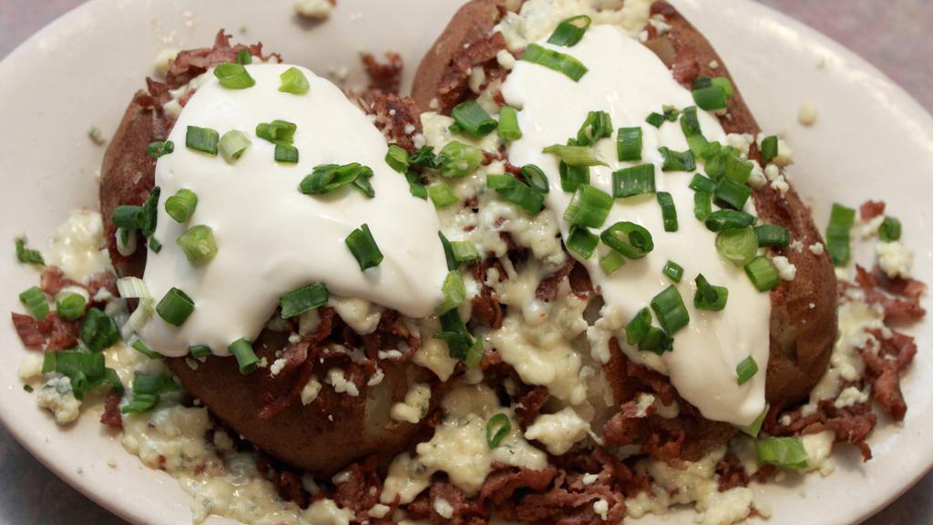 Steak & Bleu Cheese Potato · Thinly sliced sirloin, crumbled cheese, sour cream, green onions and butter.