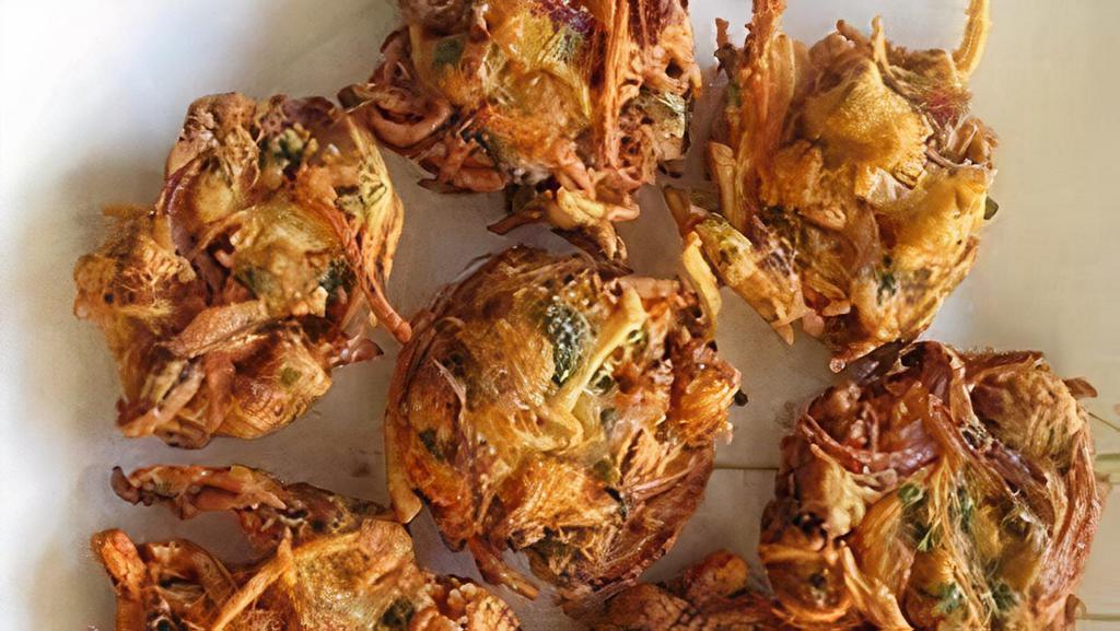 Onion Pakora · Sliced onion and spinach loosely battered with herbs, spices and deep-fried until crisp.