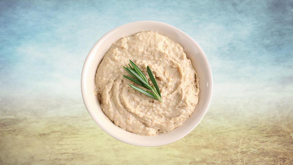 Hummus Appetizer Huba Huba · Parboiled chickpeas, mashed, blended, and mixed with generous amounts of minced garlic, tahini, and drizzled with premium olive oil.