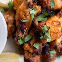 BBQ STYLE CHICKEN WINGS · roasted in our brick ovens then tossed in our spicy, tangy bbq sauce.