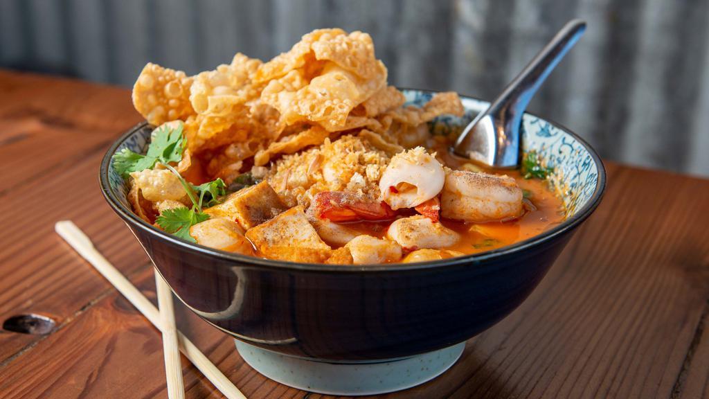 Yen Ta Foh ** · Medium Spicy. Flat rice noodles, calamari, shrimps, fish balls, tofu, spinach, green onions, cilantro, crispy wonton, in spicy red broth.