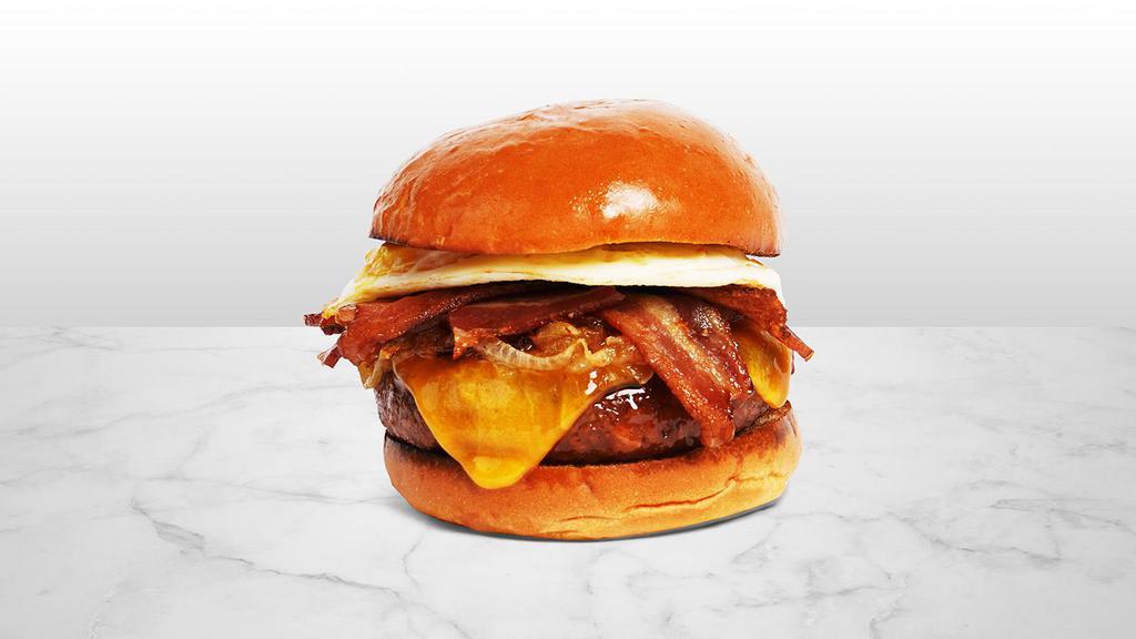 The Morning Glory Burger · Beef patty with crisp bacon, caramelized onions, melted cheddar cheese, spicy mayo, and a fried egg on a fluffy brioche bun.