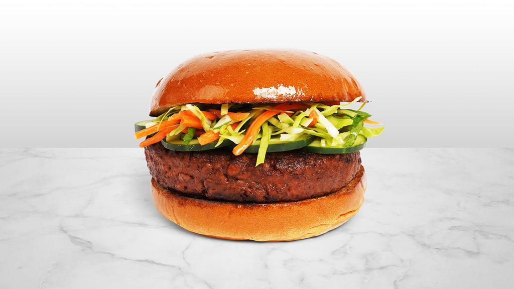 The Bahn Mi Burger · Beef patty with shredded carrot slaw, cilantro, sliced jalapenos, cucumber, and sriracha mayo on a fluffy brioche bun.