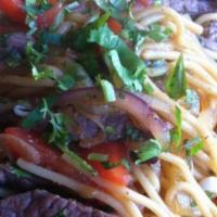 Tallarin Saltado De Carne · Spaghetti with strips of beef sautéed with onions, tomatoes and special herbs.
