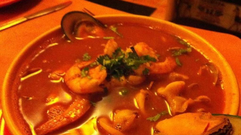 Parihuela · Shrimp, squid, clams and mussels in a soup mixed with light tomato sauce and white wine.