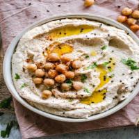 Hummus Bil Tahina · Chickpea puree with tahina, garlic, lemon juice and drizzled with extra virgin olive oil. Se...