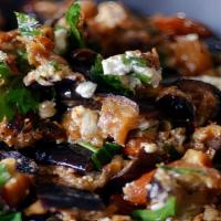 Salatet Betingen · Fried eggplant, parsley, tomato, scallions and house dressing.