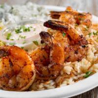 Gambari Mashwi · Grilled prawns with a butter-garlic sauce. Served with rice pilaf and daily vegetable.