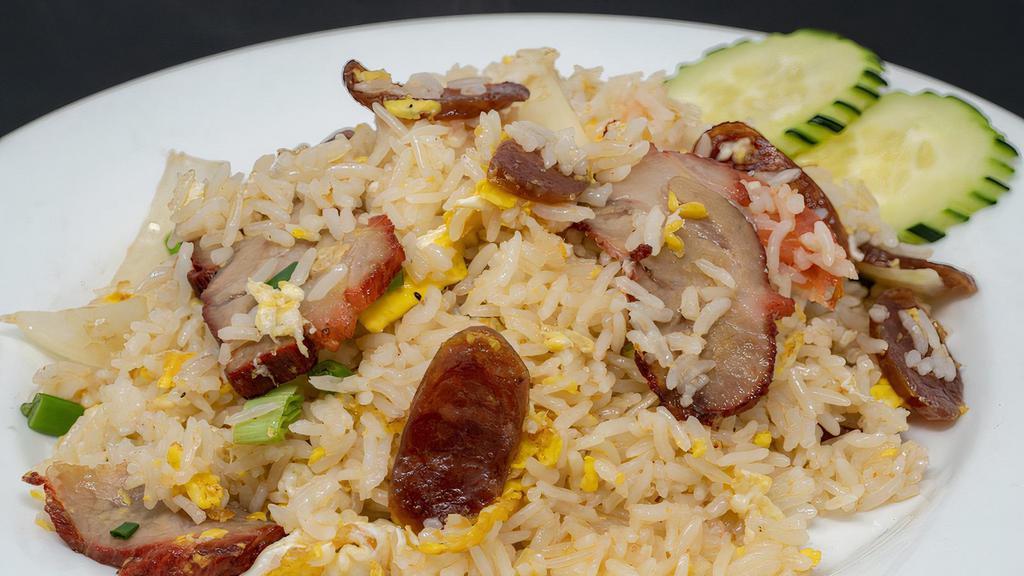 36. Barbeque Pork Fried Rice · Fried rice with barbeque pork and chinese sausage, egg, onions, tomatoes, and crab paste, topped with cilantro and cucumber.