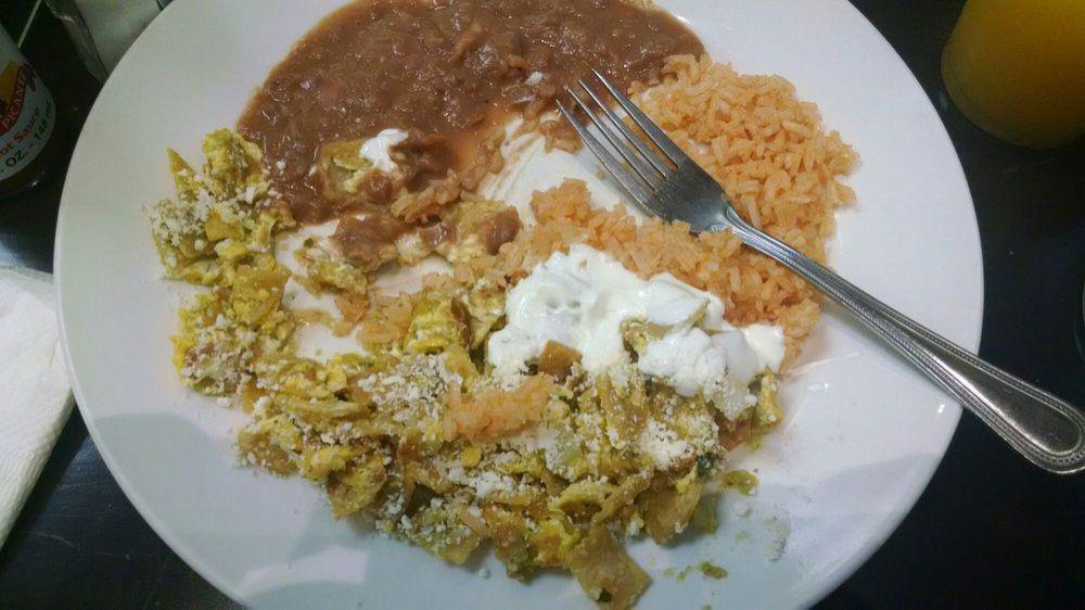 Chilaquiles · Two sunny side up eggs topped with salsa and served with rice and beans.