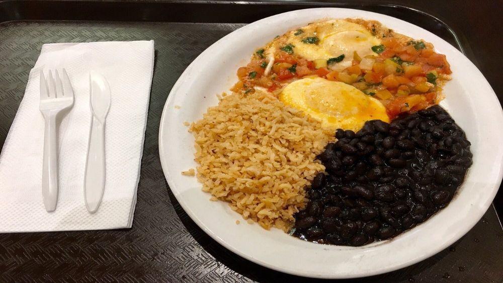 Huevos Rancheros · Two sunny side up eggs topped with salsa and served with rice and beans.