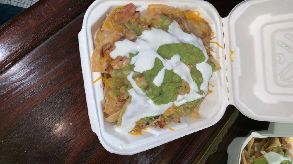 Super Nachos · With your choice of meat, beans, cheese, guacamole, sour cream and salsa.