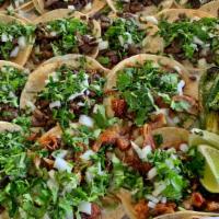 Taco Box Special · 15 tacos with your choice of meat on corn tortilla topped with onions and cilantro. Side of ...