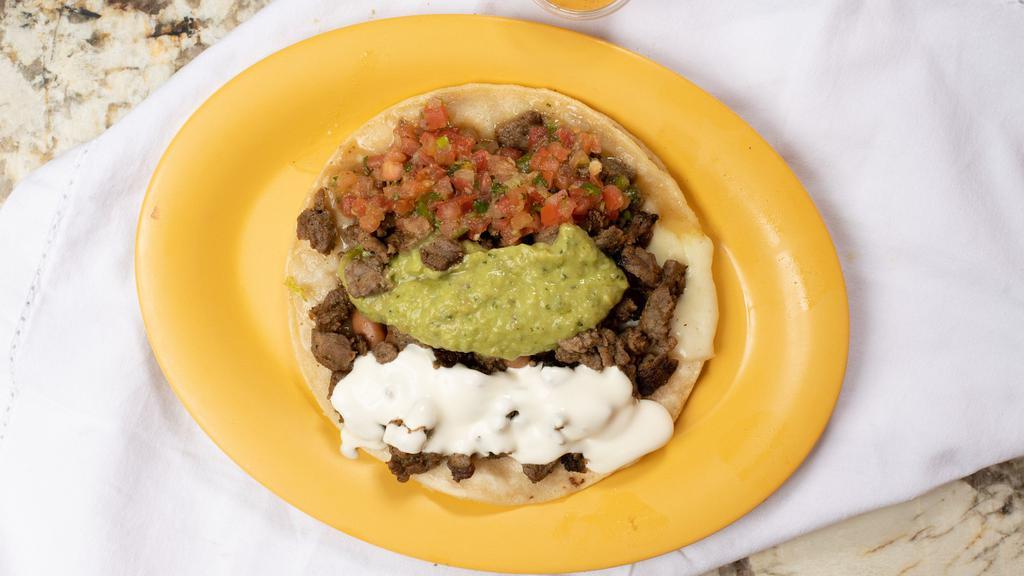 Super Taco · Whole pinto Beans, fresh salsa, cheese, sour cream, guac and your choice of meat.