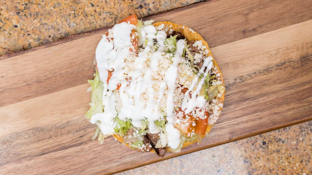 Tostadas · Crispy corn tortilla, with refried beans, lettuce, tomato, avocado, sour cream, cheese and your choice of meat.