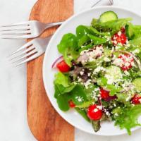 Veggie Salad · Small veggie salad full of greens, avocado and tomatoes.